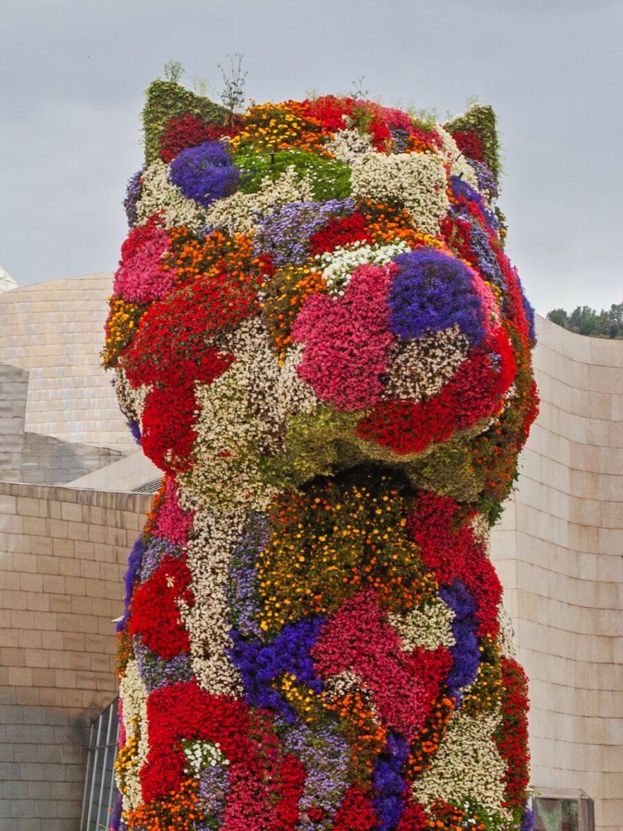 Bilbao, Spain - July 15, 2024: The floral sculpture 'Puppy' - Standing in front of Bilbao s Guggenheim Museum at 43 feet tall, the flower-covered topiary is a symbol of Spain s fifth-largest city